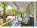 View of a lovely porch with an American flag, white railings, and relaxing seating at 3030 Baltimore St, Charleston, SC 29492