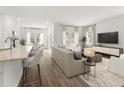 Bright living room featuring an open-concept design with hardwood floors and modern furnishings at 324 Calm Water Way, Summerville, SC 29486