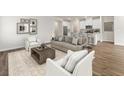 Inviting living room with neutral tones, stylish furniture, and an open floor plan to the kitchen at 324 Calm Water Way, Summerville, SC 29486