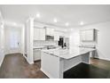 Bright kitchen with a large center island, stainless steel appliances, and ample cabinet space at 332 Long Pier St, Summerville, SC 29486
