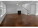Light-filled living room showcases hardwood floors, a fireplace, and stairs to the second level at 3700 Maidstone Dr, Mount Pleasant, SC 29466