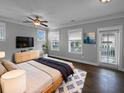 Well-lit main bedroom features a ceiling fan, balcony access, and a modern aesthetic at 3700 Maidstone Dr, Mount Pleasant, SC 29466