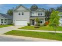 Attractive two-story home with a two-car garage, beautiful lawn, and charming landscaping at 4314 Cotton Flt Rd, Summerville, SC 29485