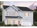 Charming two-story home with gray siding, a black roof, and an attached two-car garage at 455 White Magnolia St, Moncks Corner, SC 29461