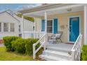 Charming front porch with a cozy seating area, offering a welcoming entrance to this delightful home at 4971 Edge Ave, Charleston, SC 29405