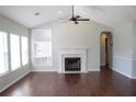 Bright living room featuring hardwood floors, fireplace, built-in shelving, and plenty of natural light at 518 Antebellum Ln, Mount Pleasant, SC 29464
