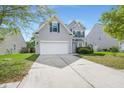 Inviting front exterior featuring a two-story home with an attached garage and a well-manicured lawn at 5224 Stonewall Dr, Summerville, SC 29485