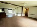 Open living space with carpet and natural light coming in the window, ready for new decor at 570 Crystal Shores Dr, Moncks Corner, SC 29461
