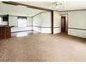Spacious living area with carpet and ample natural light, awaiting your personal touch at 570 Crystal Shores Dr, Moncks Corner, SC 29461