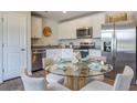 Kitchen with stainless appliances and dining area with seating for four at 6229 Gritman Dr, Hollywood, SC 29470