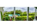Inviting backyard featuring a sparkling pool, comfortable outdoor seating, and lush landscaping for relaxation and entertainment at 711 Farm Cottage Ln, Charleston, SC 29412