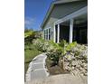 Charming home featuring a walkway flanked by lush azaleas, leading to a welcoming porch and well-maintained facade at 711 Farm Cottage Ln, Charleston, SC 29412