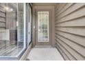 Close up of front door with sidelight and neutral exterior at 8644 Roanoke Dr, North Charleston, SC 29406