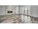 Spacious living room featuring wood floors and an electric fireplace at 8644 Roanoke Dr, North Charleston, SC 29406
