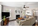 Comfortable living room featuring a fireplace, neutral colors, and plenty of natural light at 8986 N Red Maple Cir, Summerville, SC 29485