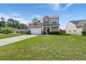 Charming two-story home featuring a well-maintained lawn and an attached two-car garage at 9731 Stockport Cir, Summerville, SC 29485