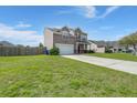 Two-story home with a well-manicured lawn, driveway, and an attached two-car garage at 9731 Stockport Cir, Summerville, SC 29485