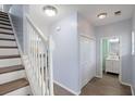 Bright hallway with wood floors, white staircase and trim, leading to an open-concept living space at 9731 Stockport Cir, Summerville, SC 29485
