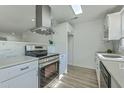 Bright kitchen with stainless steel appliances, a modern range hood, and sleek countertops at 100 Lipman St, Summerville, SC 29483