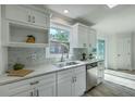 Modern kitchen with white cabinets, stainless steel appliances, and a marble tile backsplash at 100 Lipman St, Summerville, SC 29483