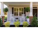 Inviting front porch with rocking chairs, and fresh greenery at 10032 Randall, McClellanville, SC 29458