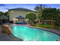 Backyard with swimming pool, outdoor seating and lush landscaping, perfect for entertaining at 101 Writing Ct, Ladson, SC 29456