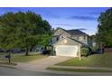 Two-story home with an attached garage, well-maintained lawn, and mature trees at 101 Writing Ct, Ladson, SC 29456