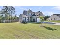 Beautiful two-story home with a well-maintained lawn and landscaping, offering great curb appeal at 106 Lakelyn Rd, Moncks Corner, SC 29461