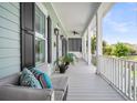Inviting front porch with comfortable seating, fan, and stylish decor at 1063 Hills Plantation Dr, Charleston, SC 29412