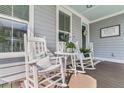 Cozy front porch with white rocking chairs and table, perfect for relaxing outdoors at 113 Sugarberry Way, Summerville, SC 29485