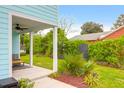 Inviting back porch with comfortable seating and view of the private backyard and brick house at 1130 5Th Ave, Charleston, SC 29407