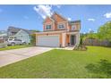 Charming two-story home featuring a two-car garage, manicured lawn, and inviting curb appeal at 120 Indigo Marsh Cir, Wando, SC 29492