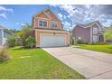 Charming two-story home featuring a two-car garage, manicured lawn, and inviting curb appeal at 120 Indigo Marsh Cir, Wando, SC 29492