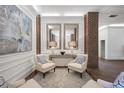 Elegant lobby area featuring stylish chairs, mirrors, brick columns, and modern art at 14 Lockwood Dr # 6E, Charleston, SC 29401