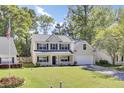 Inviting two-story home with a manicured front yard and an American flag, showcasing a blend of comfort and patriotic pride at 150 Sugar Magnolia Way, Charleston, SC 29414
