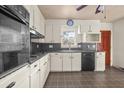 Galley-style kitchen features white cabinets, sleek countertops, and modern appliances at 1501 Birthright St, Charleston, SC 29407