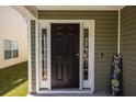 Elegant black front door with sidelights, creating a welcoming and stylish entrance to the home at 187 Brittondale Rd, Summerville, SC 29485