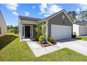 Inviting front entrance featuring a well-manicured lawn and tidy landscaping, enhancing curb appeal at 187 Brittondale Rd, Summerville, SC 29485