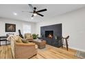Cozy living room with a modern fireplace, hardwood floors, and stylish furnishings, perfect for relaxation at 1897 Halo Ln, Charleston, SC 29407