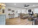Open-concept living room featuring hardwood floors, modern decor, and a seamless flow to the dining area at 1897 Halo Ln, Charleston, SC 29407