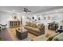 Inviting living room with hardwood floors, a wicker sofa, and an open layout that leads to the kitchen at 1897 Halo Ln, Charleston, SC 29407