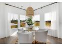 Bright dining area with large windows providing scenic views and a stylish chandelier creating an inviting space at 195 Belfort Pl, Summerville, SC 29486