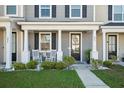 Inviting porch with rocking chairs, manicured landscaping, and decorative door wreath enhances curb appeal at 202 Kirkland St, Goose Creek, SC 29445