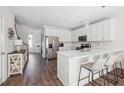 Modern kitchen with white cabinets, stainless steel appliances, and a stylish island with bar seating at 202 Kirkland St, Goose Creek, SC 29445