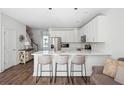 Bright kitchen features white cabinets, stainless steel appliances, and an island with seating at 202 Kirkland St, Goose Creek, SC 29445