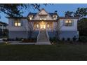 Inviting two-story house with a well-lit entrance, charming shutters, and manicured landscaping at 2312 Rushland Landing Rd, Johns Island, SC 29455