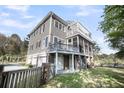 This home boasts a screened in porch, balcony with pergola, and a multi-car garage at 2340 Salt Wind Way, Mount Pleasant, SC 29466