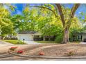 Well-kept single-story house featuring beautiful landscaping, mature trees, and a convenient two-car garage at 301 Huntington Ct, Hanahan, SC 29410