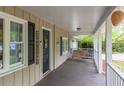 Inviting front porch with a swing and dark wood flooring providing a relaxing outdoor space at 306 Fairlawn Drive, Moncks Corner, SC 29461