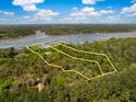 Aerial view of a large property with beautiful trees, surrounding landscape, and waterfront access at 3060 Bohicket Rd, Johns Island, SC 29455
